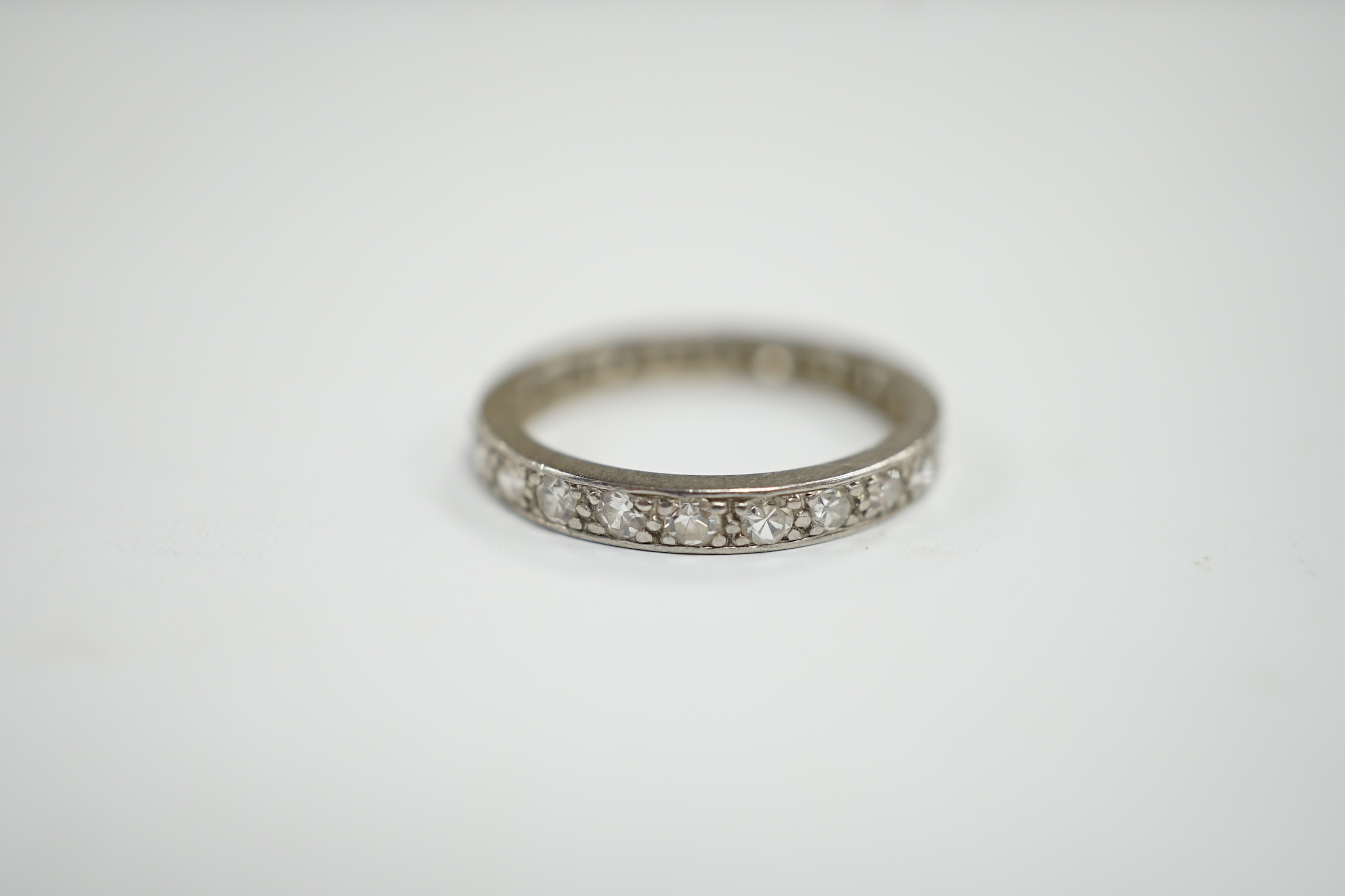 A white metal and diamond set full eternity ring, size M, gross weight 2.9 grams.